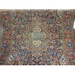 Kashan rug with medallion all-over floral design on a midnight blue ground with borders, 82ins x