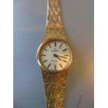 Ladies 9ct gold cased Omega Deville wristwatch on a 9ct gold integral textured bracelet with