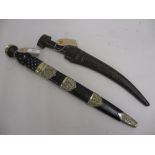 Scottish dirk with metal mounted scabbard together with an Arab dagger with leather scabbard