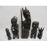 South Pacific ebonised carved wooden figure of a man with grotesque face holding a club, 12ins