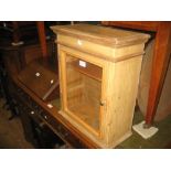 Small pine wall cupboard with glazed panel door