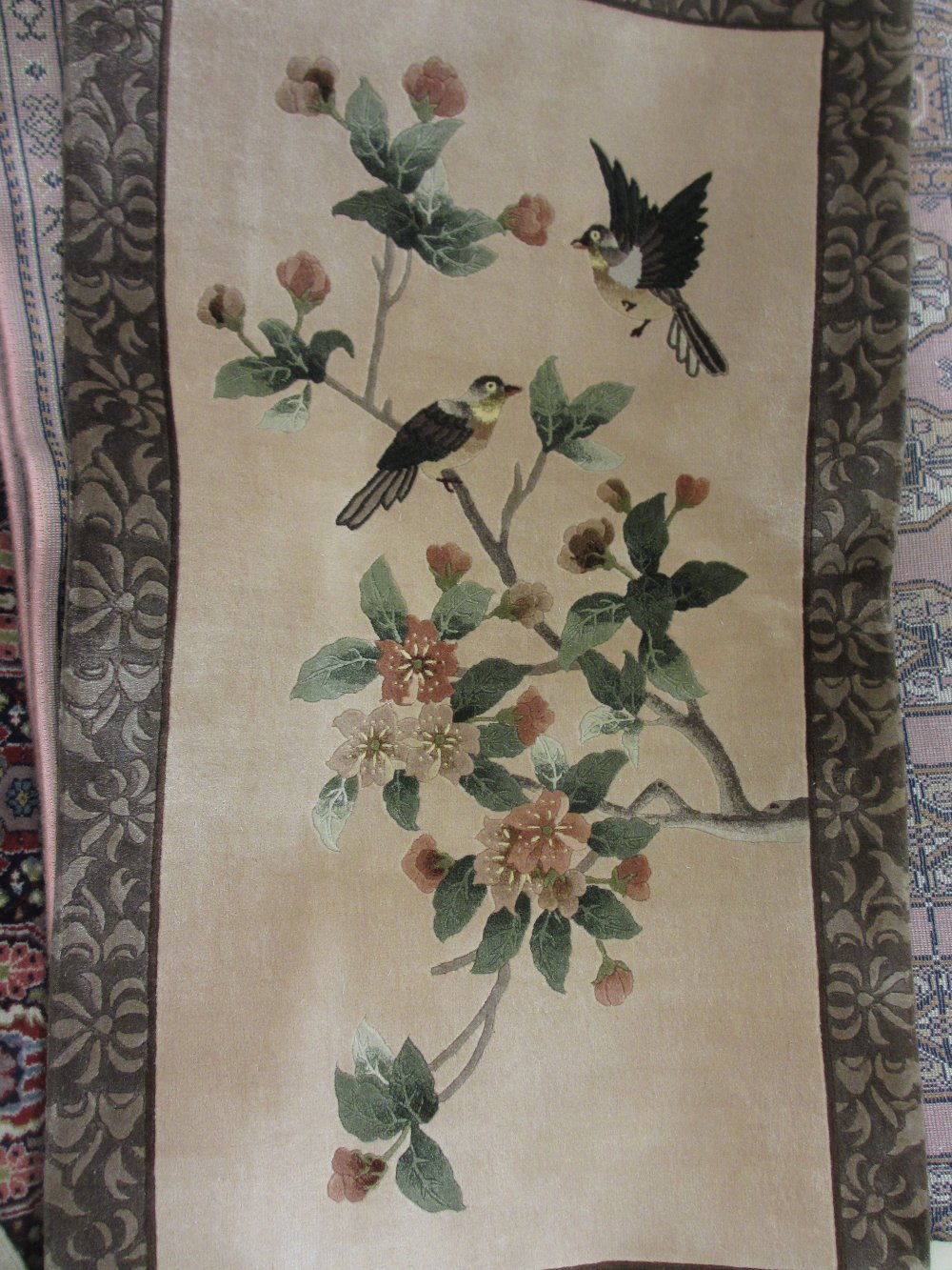 Near pair of modern Chinese silk rugs with floral and bird designs with beige ground with borders,