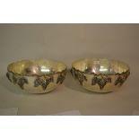 Pair of reproduction silver plated wine coolers with relief moulded grape vine decoration