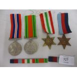 Group of four World War II medals with ribbons including the Italy Star and the 39 / 45 Star