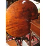 18th Century mahogany circular pedestal tilt top table raised on a turned and wrythen column and