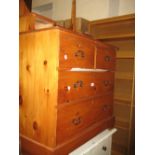 Pine washstand with oval swing mirror above jewel drawers, together with a pine open bookshelf