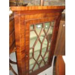 George III mahogany hanging corner cabinet with a single astragal glazed door