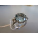 18ct White gold ring set circular aquamarine with diamond set shoulders