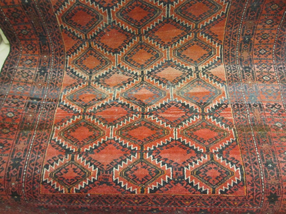 Afghan rug with all-over hooked medallion design on red ground