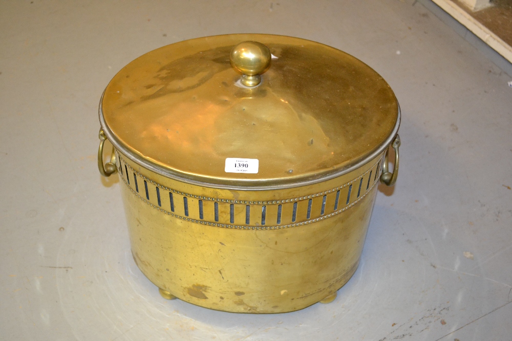 Edwardian brass oval two handled coal bucket with cover and liner on low bun supports
