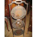 Circular mahogany three tier folding cake stand together with an antique copper warming pan