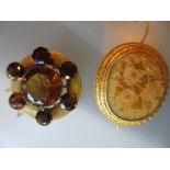 Yellow metal brooch set brown citrines and a carved floral cameo brooch in a yellow metal setting