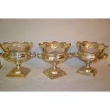 Set of three reproduction silver plated wine coolers on square platform bases