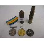 Three World War I military medals and two Trench Art cigarette lighters made from bullet casings