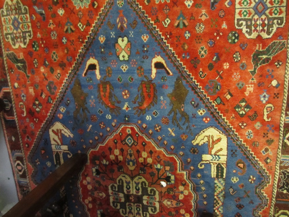 Modern Qashqai rug with medallion and all-over stylised floral and boteh designs on a red and blue