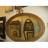 19th Century oval gilt framed bevelled edge wall mirror with urn surmount (a/f)