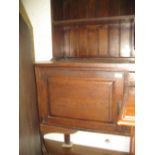 Late 19th or early 20th Century oak dresser with a boarded shelf back incorporating a leaded glass