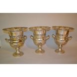 Set of three large reproduction silver plated wine coolers on circular plinth bases