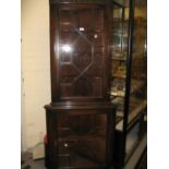 Edwardian mahogany standing corner cabinet with moulded and blind fretwork cornice above two