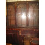 Late George III mahogany bookcase with a flush cornice above three bar glazed doors and two