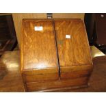 Victorian oak slope front stationery cabinet with two doors enclosing a fitted interior