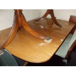 Mahogany pedestal dining table, the figured reeded top with D-ends raised on turned column supports