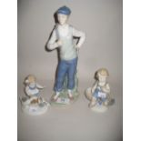 Nao figure of a golfer and two similar smaller figures