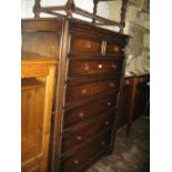 Reproduction oak straight front chest of two short and five long drawers with knob handles on stile