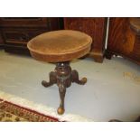 Victorian carved walnut piano stool with revolving seat on tripod base