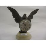 Unusual early 20th Century brass clock with domed glass suspended from a spelter figure of an eagle