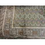 Modern green ground Bokhara pattern machine made rug, 1.9m x 1.