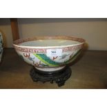 Chinese famille vert bowl decorated with dragons (chipped and cracked to the rim) on a carved