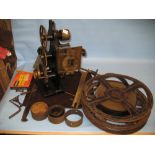 Early 20th Century film projector together with a quantity of rolls of film etc