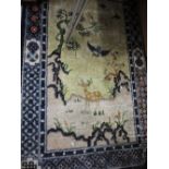 Small Chinese silk style rug with floral and vase design on a beige ground with borders,