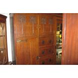 Arts and Crafts oak three section wardrobe with oversized moulded cornice above an arrangement of
