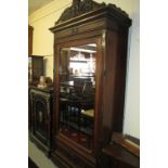 Late 19th Century French rosewood veneered wardrobe having moulded and carved top above a single