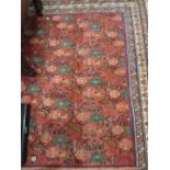 Hamadan rug with all-over stylised floral design on a red ground with triple border,