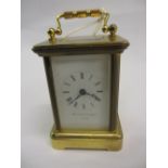 Miniature gilt brass cased carriage clock with enamel dial and Roman numerals, signed Mathew Norman,