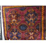 Afghan Belouch rug with eight medallions on a wine red ground with narrow border,