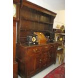 George III oak dresser with boarded shelf back above four centre drawers flanked by two further