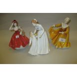 Two Royal Doulton figures of ladies together with a similar Coalport figure of a lady