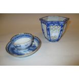 Chinese blue and white tea bowl and saucer decorated with pagodas in a landscape,