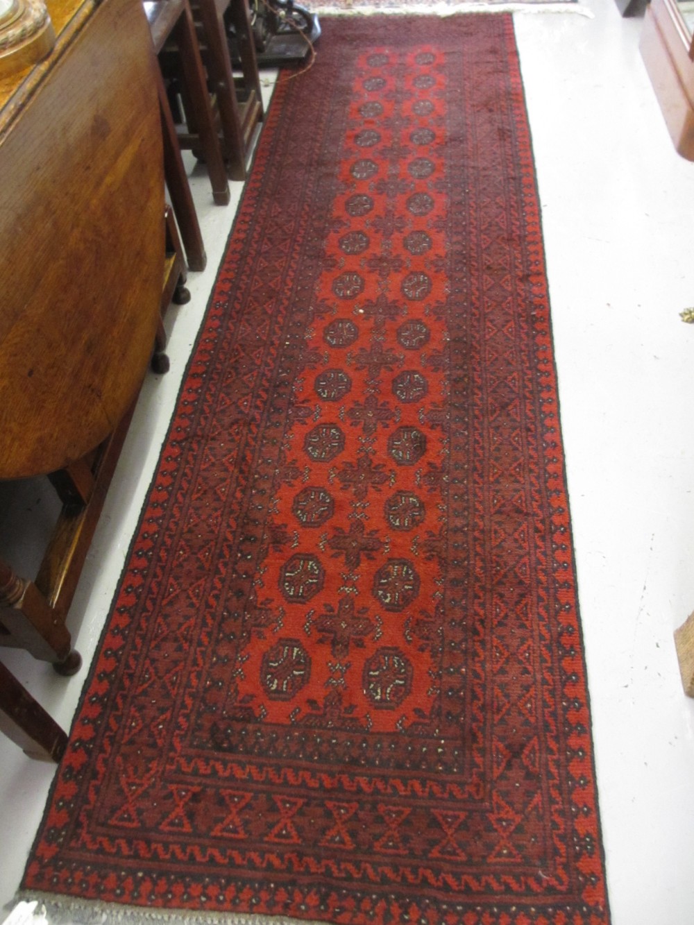 Modern red ground Afghan runner, 2.86m x 0.