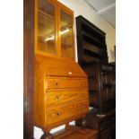 Light oak bureau bookcase circa 1930 with two glazed doors above a fall front and drawers on