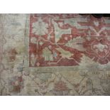 20th Century rug with all-over floral design on a beige ground with borders,
