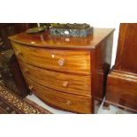 Regency mahogany bow fronted chest of three long drawers with knob handles raised on splay supports