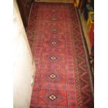 Turkoman rug with single row of hooked gols on a wine ground with borders,