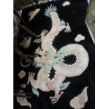 Chinese rug with dragon design on a black ground,