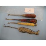 Four various 19th Century button hooks including one steel in the form of a leg