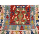 Small Kelim rug with geometric designs in pastel tones